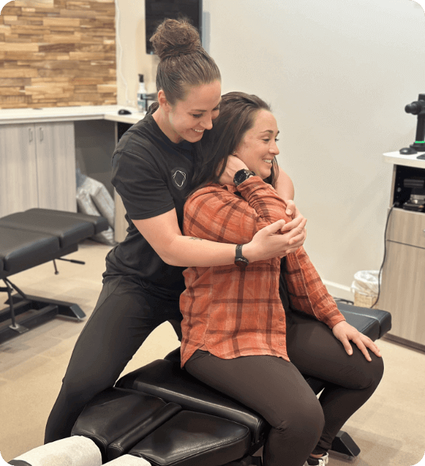 Dr. Tara adjusting a female patient's arm