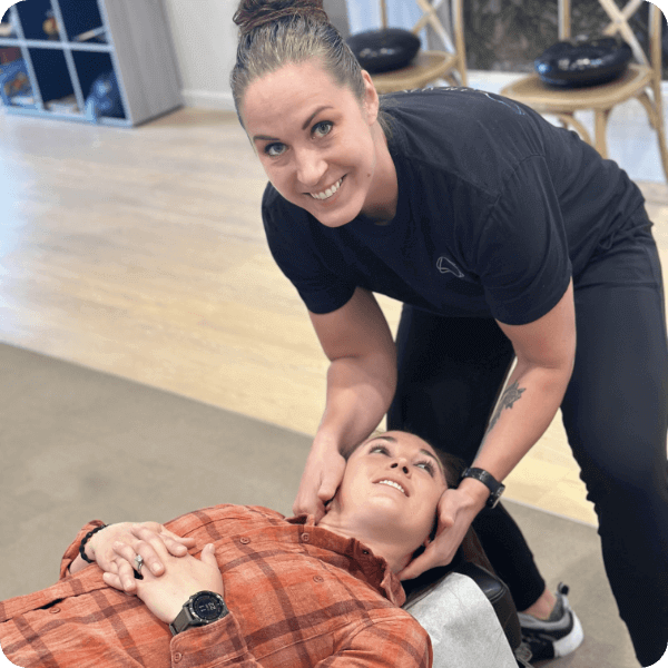 Dr. Tara adjusting female patient's neck