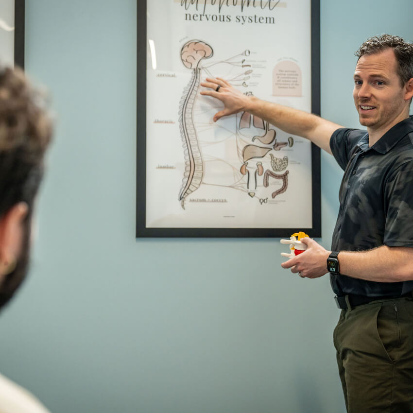 Dr Alec pointing to spine model