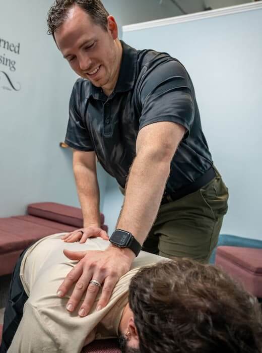 doctor checking athlete's back