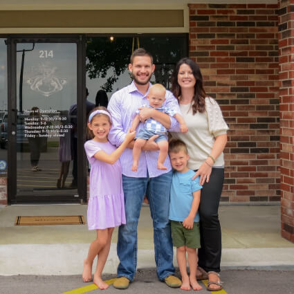 Dr. Ryan and family standing outside of the practice