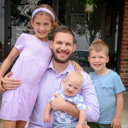 Dr. Ryan and kids outside of the practice