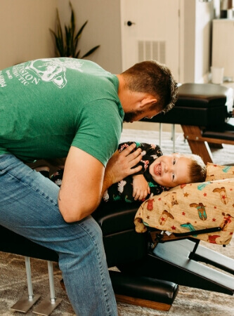 Chiropractor adjusting toddler