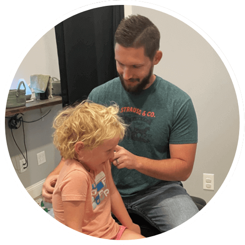 Chiropractor adjusting child