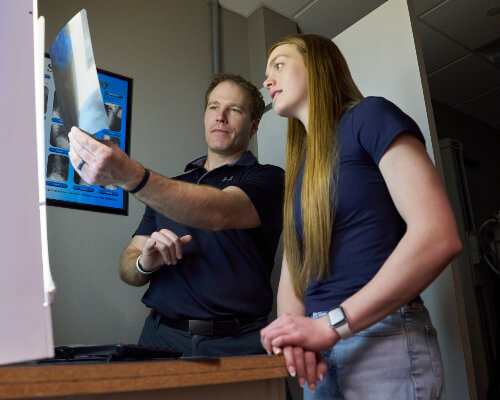Doctor looking at xrays with patient