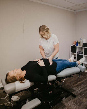 Dr. Leslie adjusting a pregnant woman