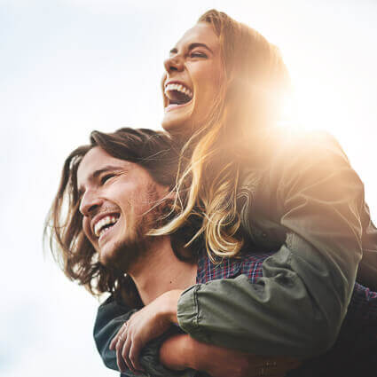 couple piggyback ride laughing