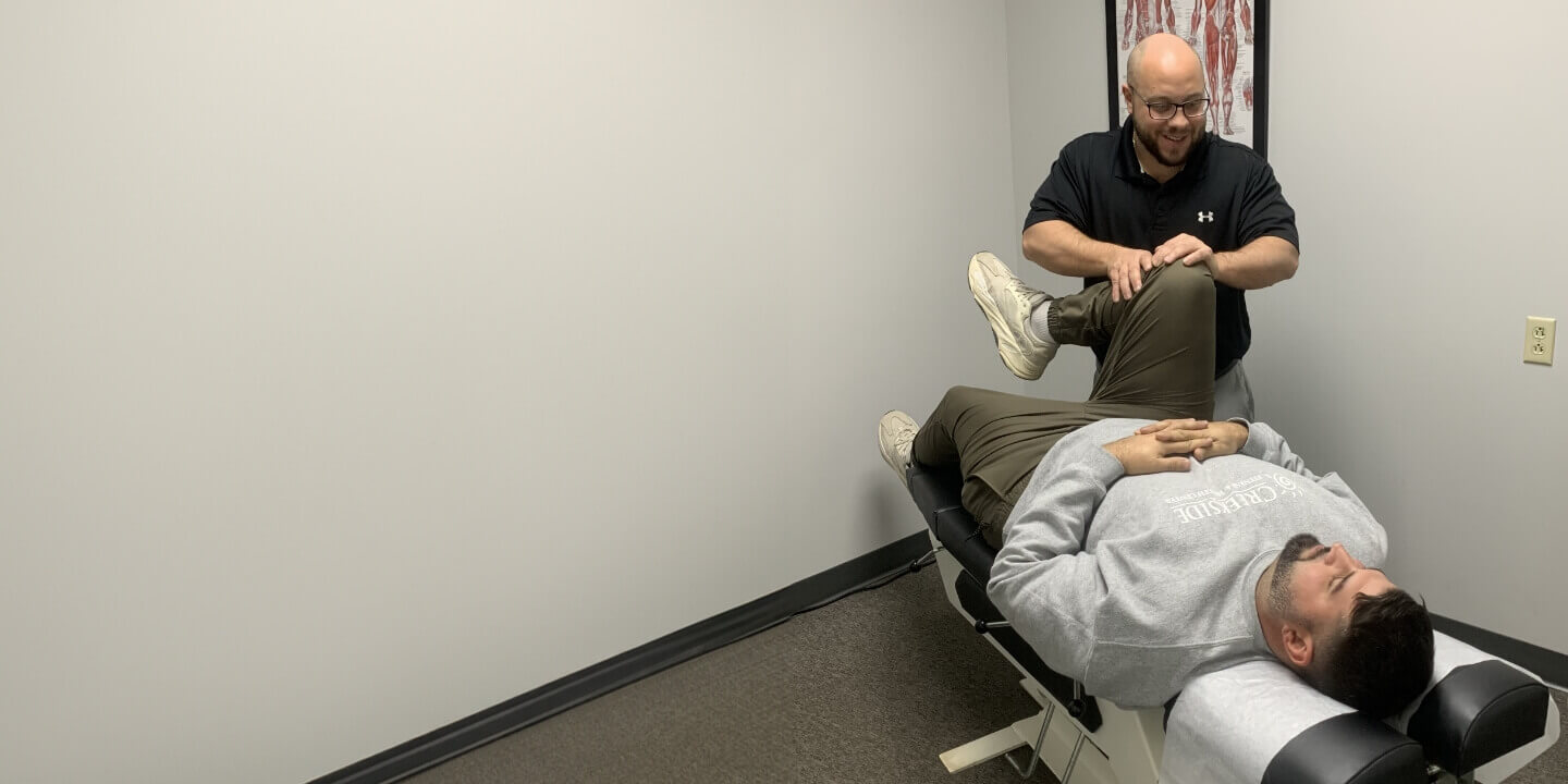 doctor adjusting patients knee