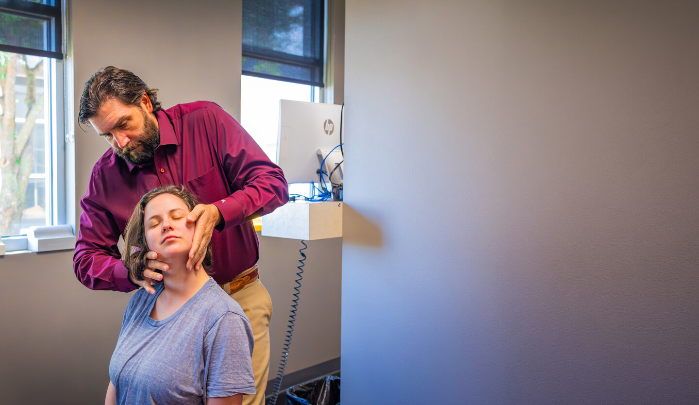 Chiropractor adjusting patient