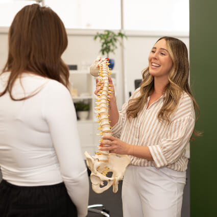 Dr. Hansen holding spine model