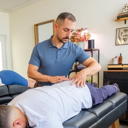 Dr Nick adjusting patients back