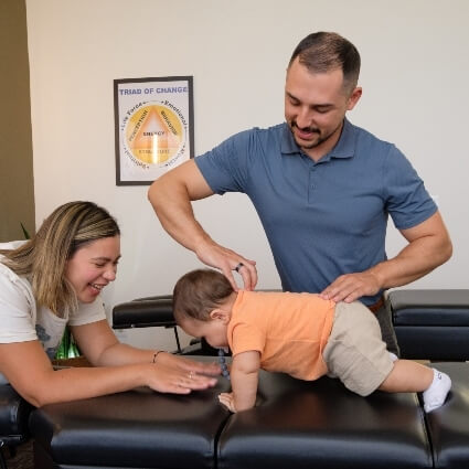 Dr Nick adjusting baby
