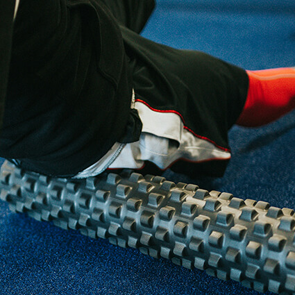 person using foam roller