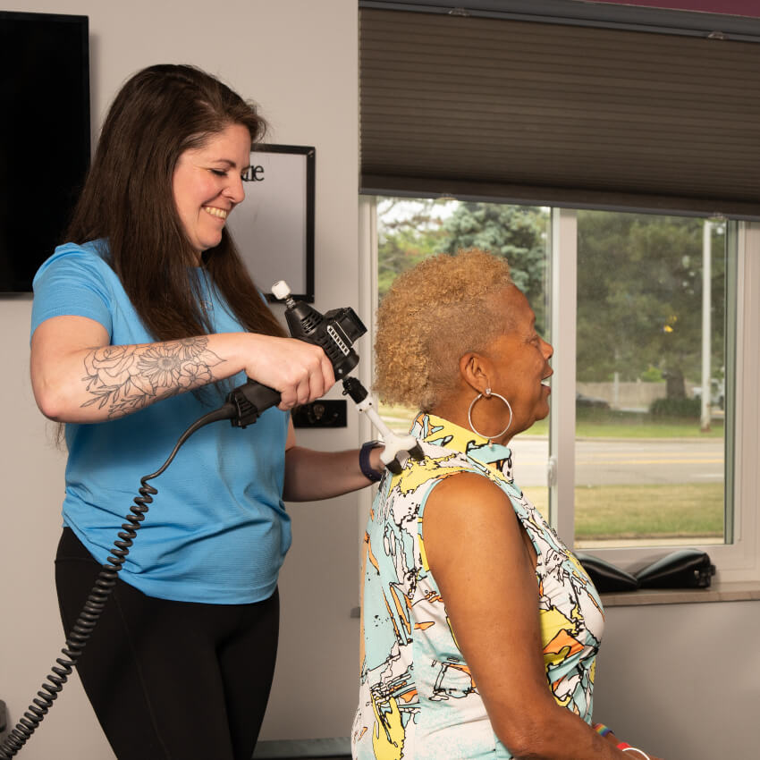 doctor adjusting patient with tool