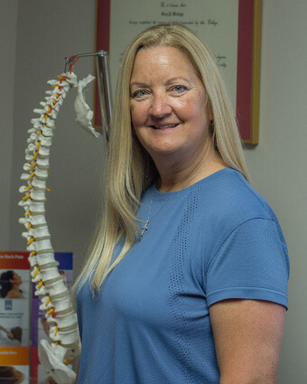 Dr. Mary holding spine model