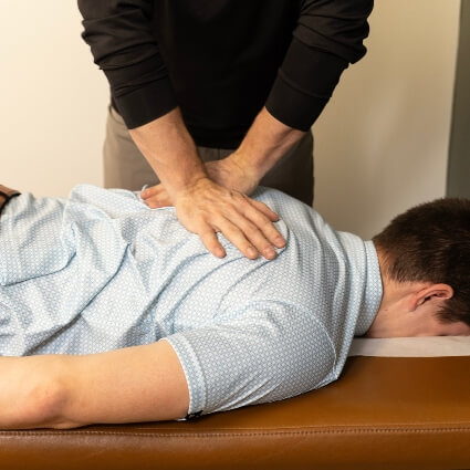 patient having upper back adjusted