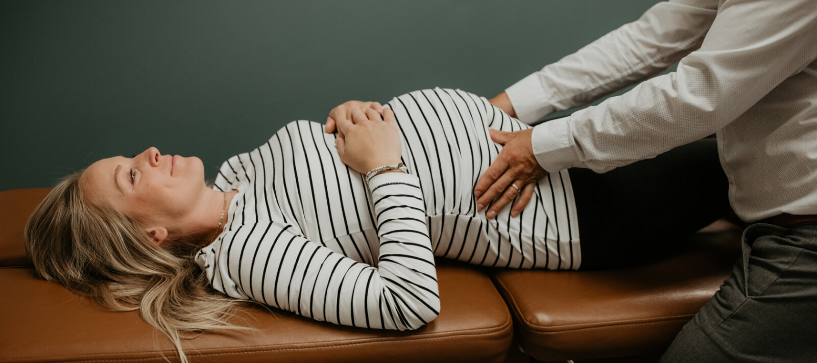 pregnant Clear Health and Wellness patient having back adjusted