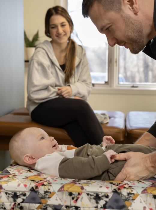 St Louis Park chiropractor smiling at baby