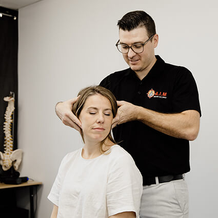 Dr. Luke, Chiropractor in Shailer Park, performing a neck adjustment