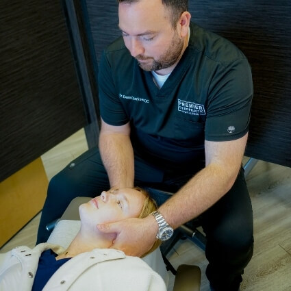 doctor adjusting persons neck