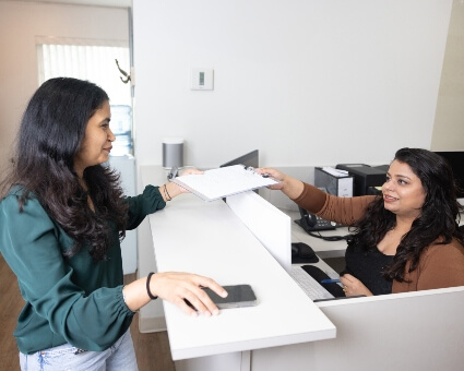 Reception staff interacting with patient