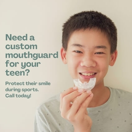 kid putting mouthguard in mouth