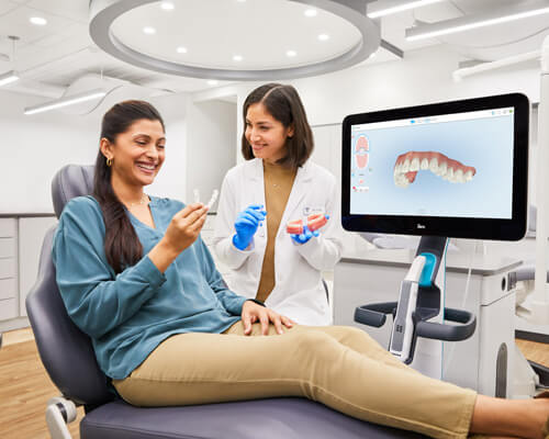 Woman holding aligner