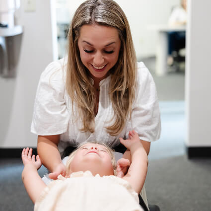 Smileing while adjusting toddler