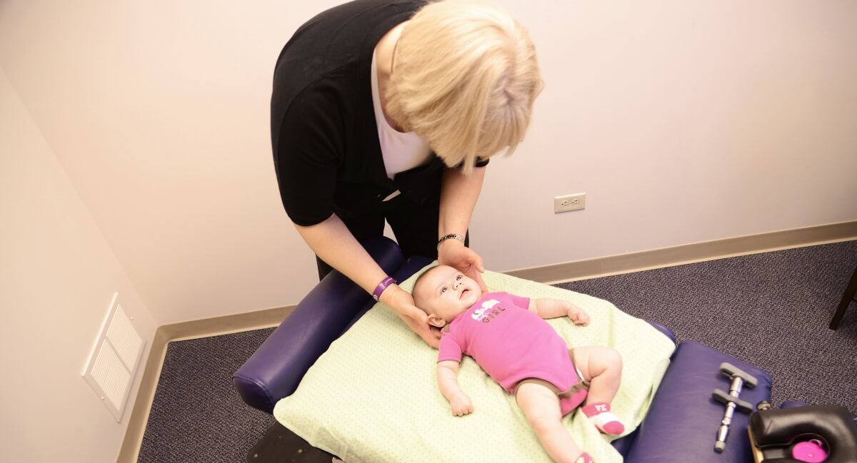 Yorkville chiropractor Dr. Cornish adjusting pediatric patient