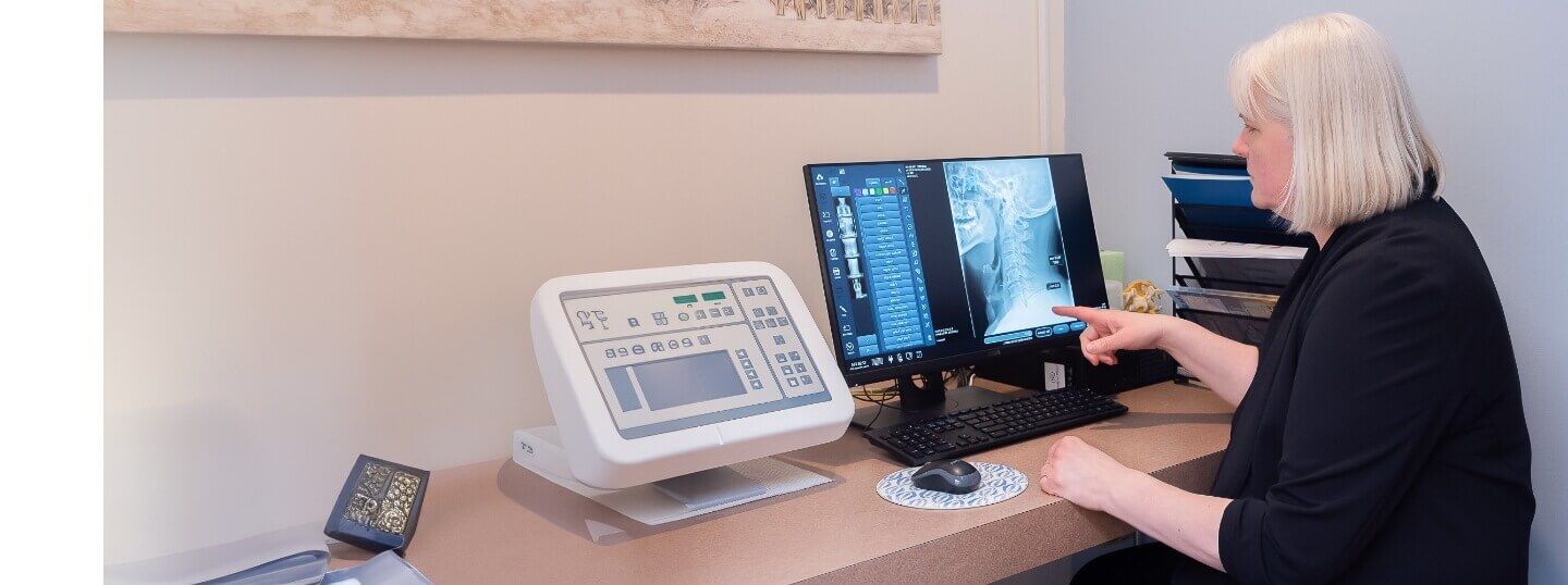 Yorkville chiropractor Dr. Lea Cornish inspecting an x-ray result