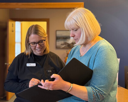 Cornish Chiropractic staff members looking at file