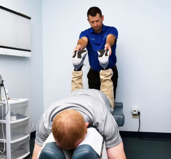 Portage chiropractor Dr Nick adjusting patients legs