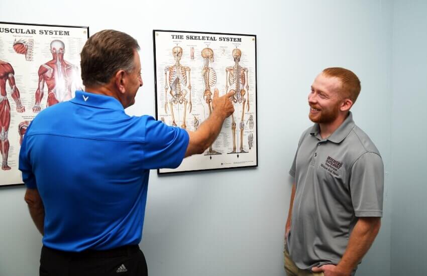 Alfieri Chiropractic Clinic doctor explaining chart to patient