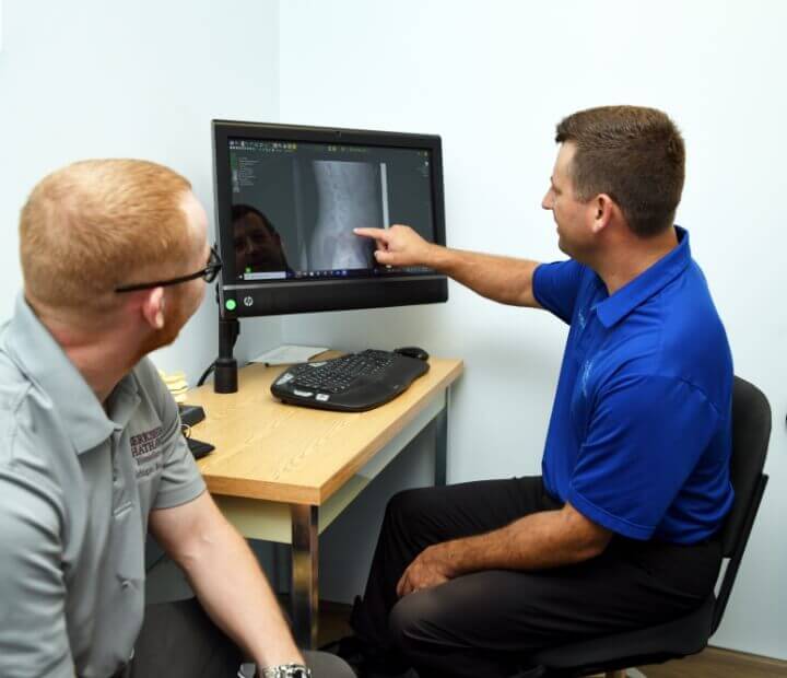 Portage Chiropractor Dr Nick explaining xray to patient