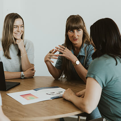 coworkers talking at a table
