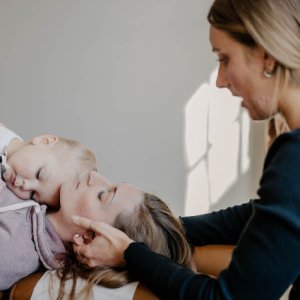 dr-s-adjusting-moms-neck-with-boy-on-her-chest