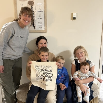 family smiling with our doctor