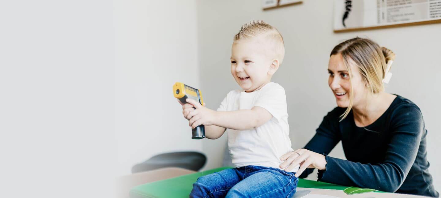 Transform Chiropractic Wellness Center Chiropractor Dr. Stephanie examining child on adjusting table