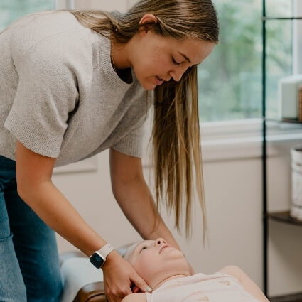 child having neck adjusted