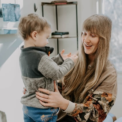 child standing with one of our doctors