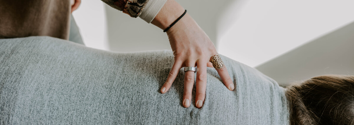chiropractor with hand on patients back