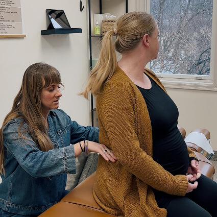 Shoreview chiropractor adjusting pregnant patients back