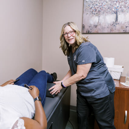 Grain Valley Chiropractic Chiropractor Dr. Catherine with patient on traction table