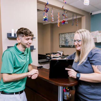 Grain Valley Chiropractor Dr. Lindsey speaking with patient