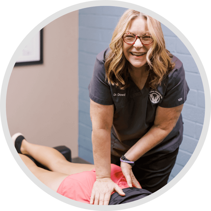 Grain Valley Chiropractor Dr Catherine Dowd smiling while adjusting