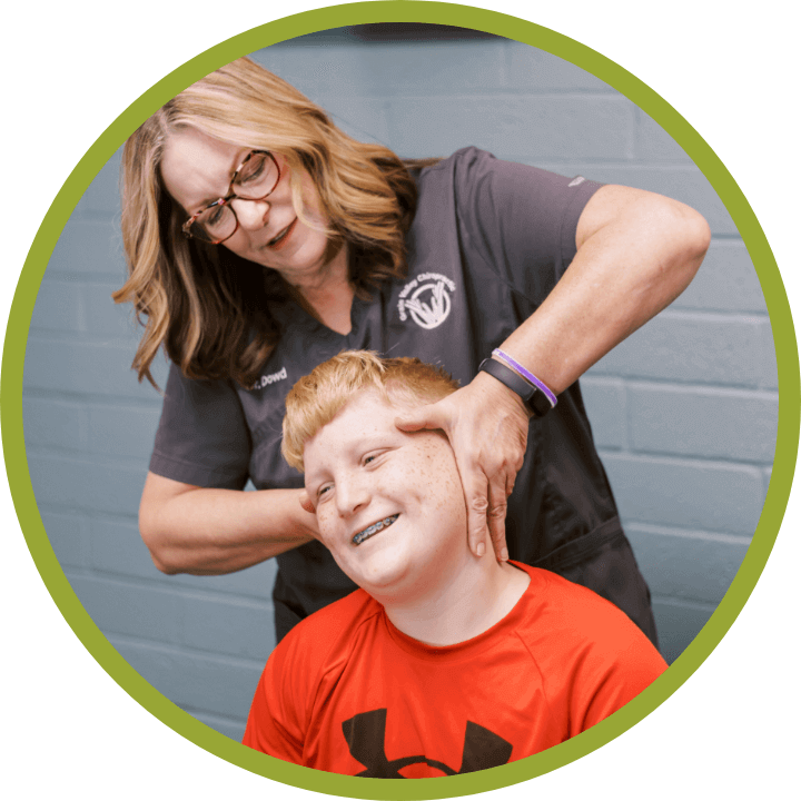 Grain Valley Chiropractor Dr Catherine Dowd adjusting patient's neck