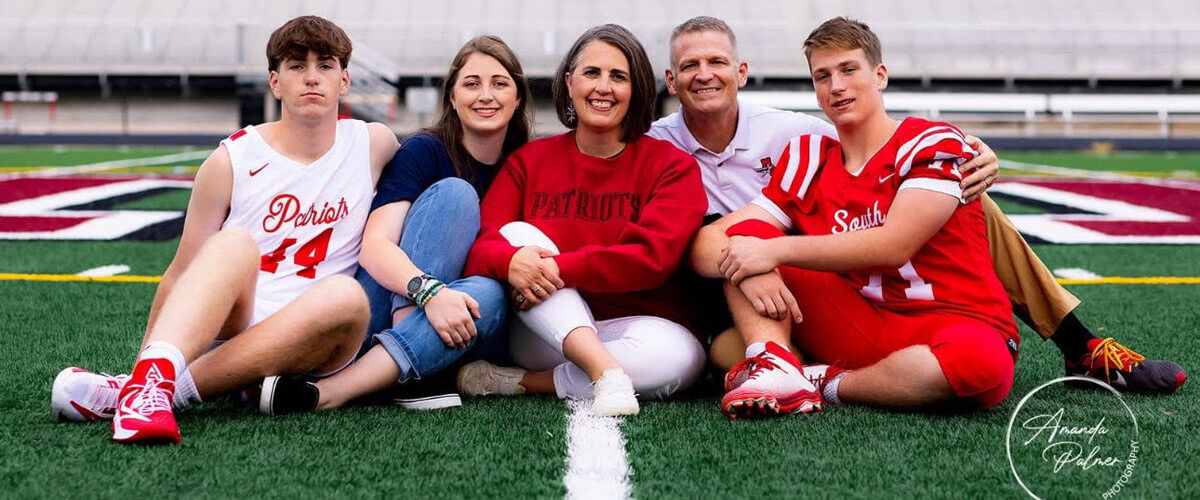Dr. Sheri and family sitting in field
