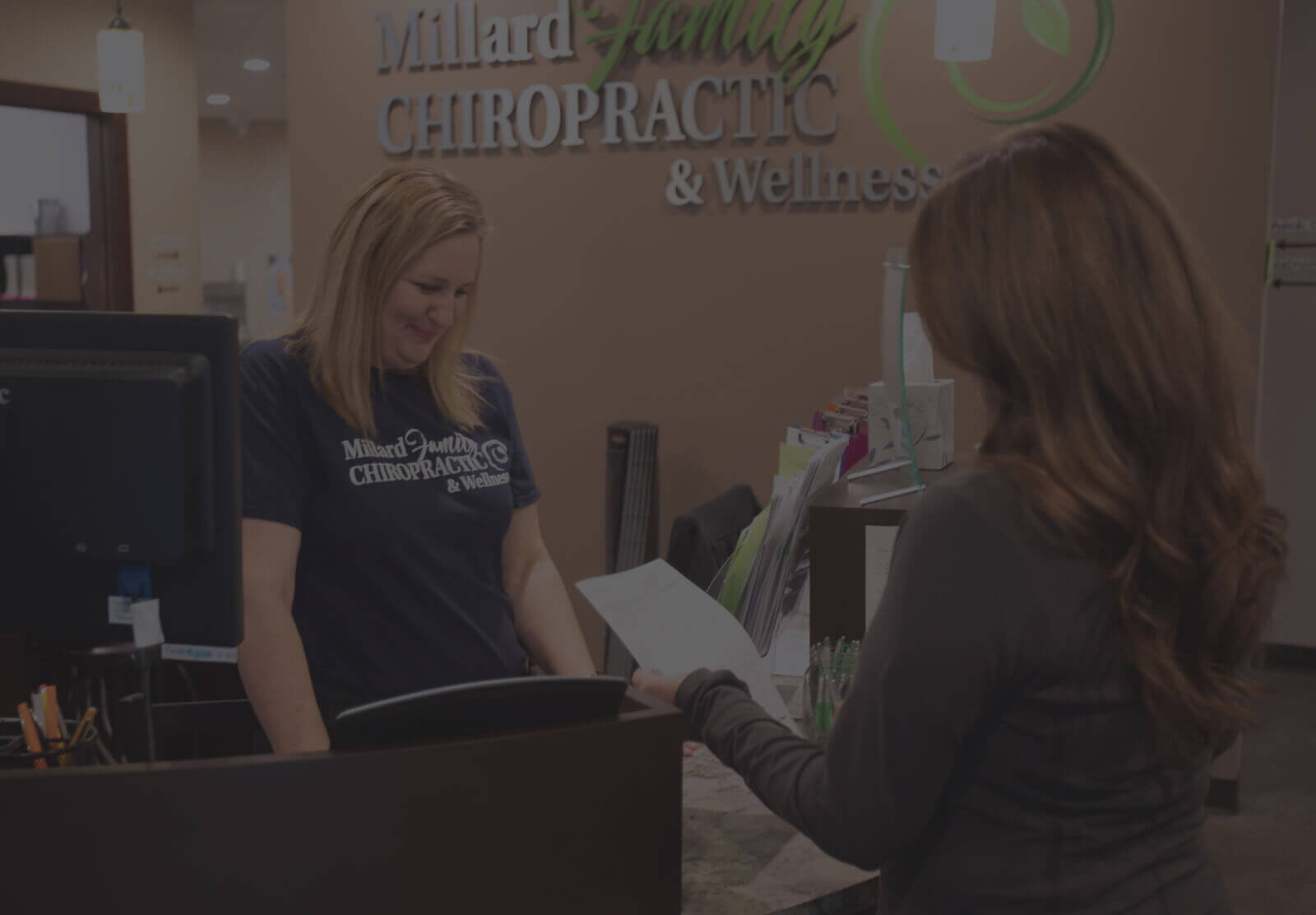 Millard Family Chiropractic & Wellness receptionist interacting with Omaha patient