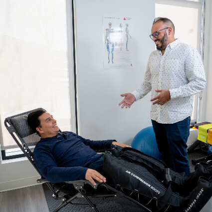 Dr. Allykhan talking to patient in chair