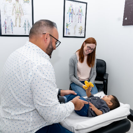 Dr. Allykhan adjusting young child